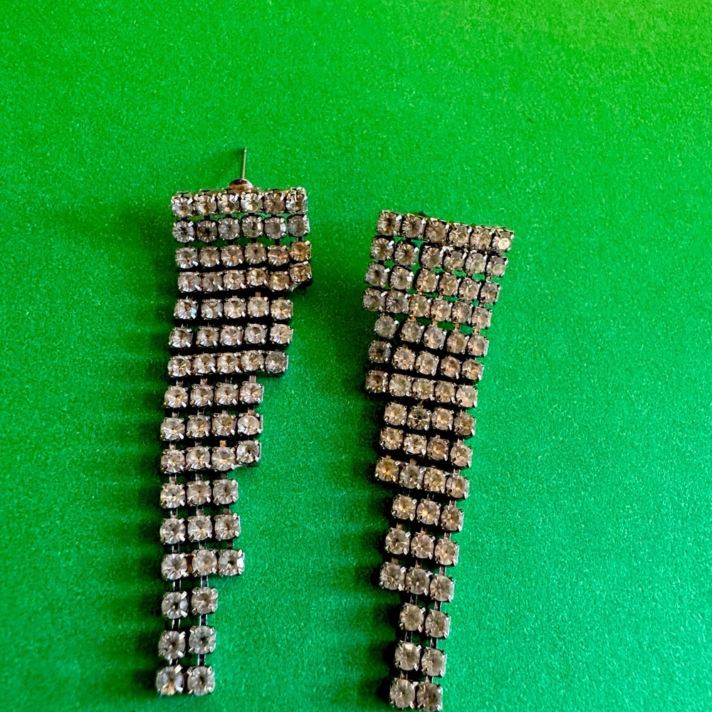Glamorous 2” silver-tone rhinestone earrings with protective earring backs.